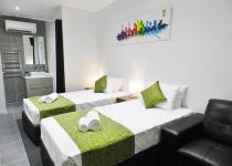 Single beds and bathroom in Family Studio Room